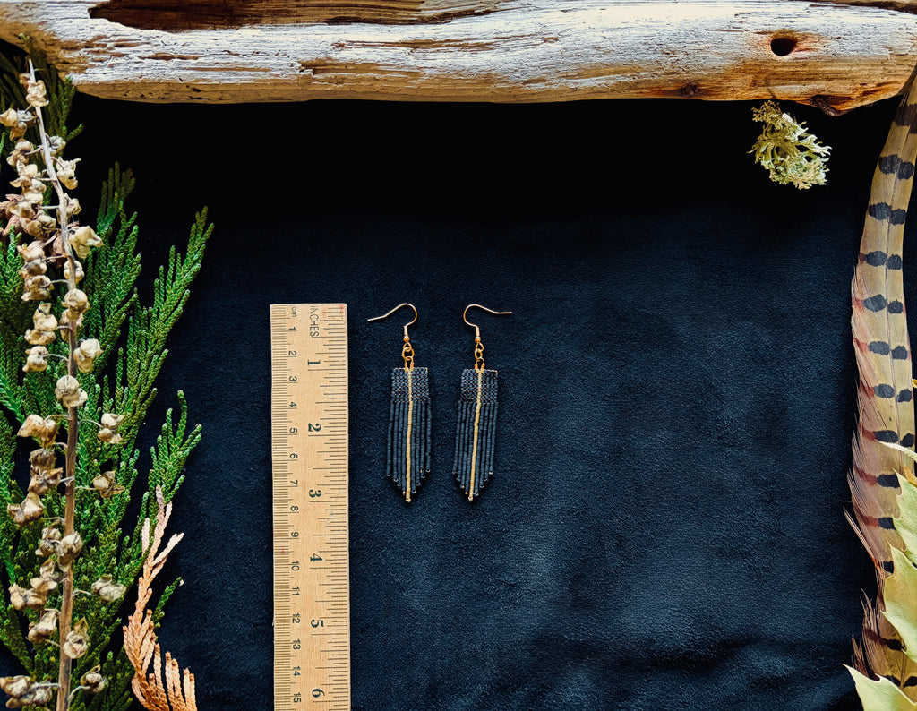 Matte Black & Silver Beaded fringe earrings on a black background next to a wooden ruler measuring 3"