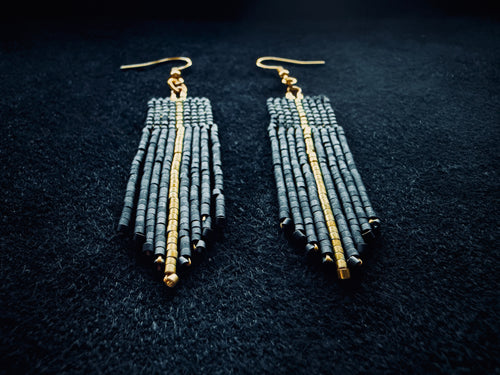Matte Black & gold beaded fringe earrings on a black background